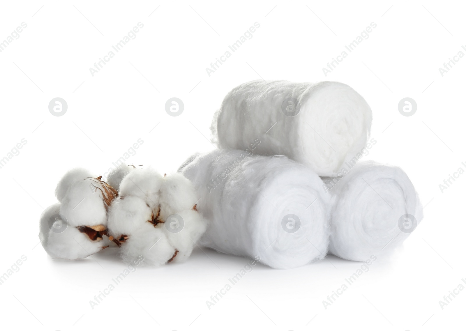 Photo of Fluffy cotton rolls and flowers on white background