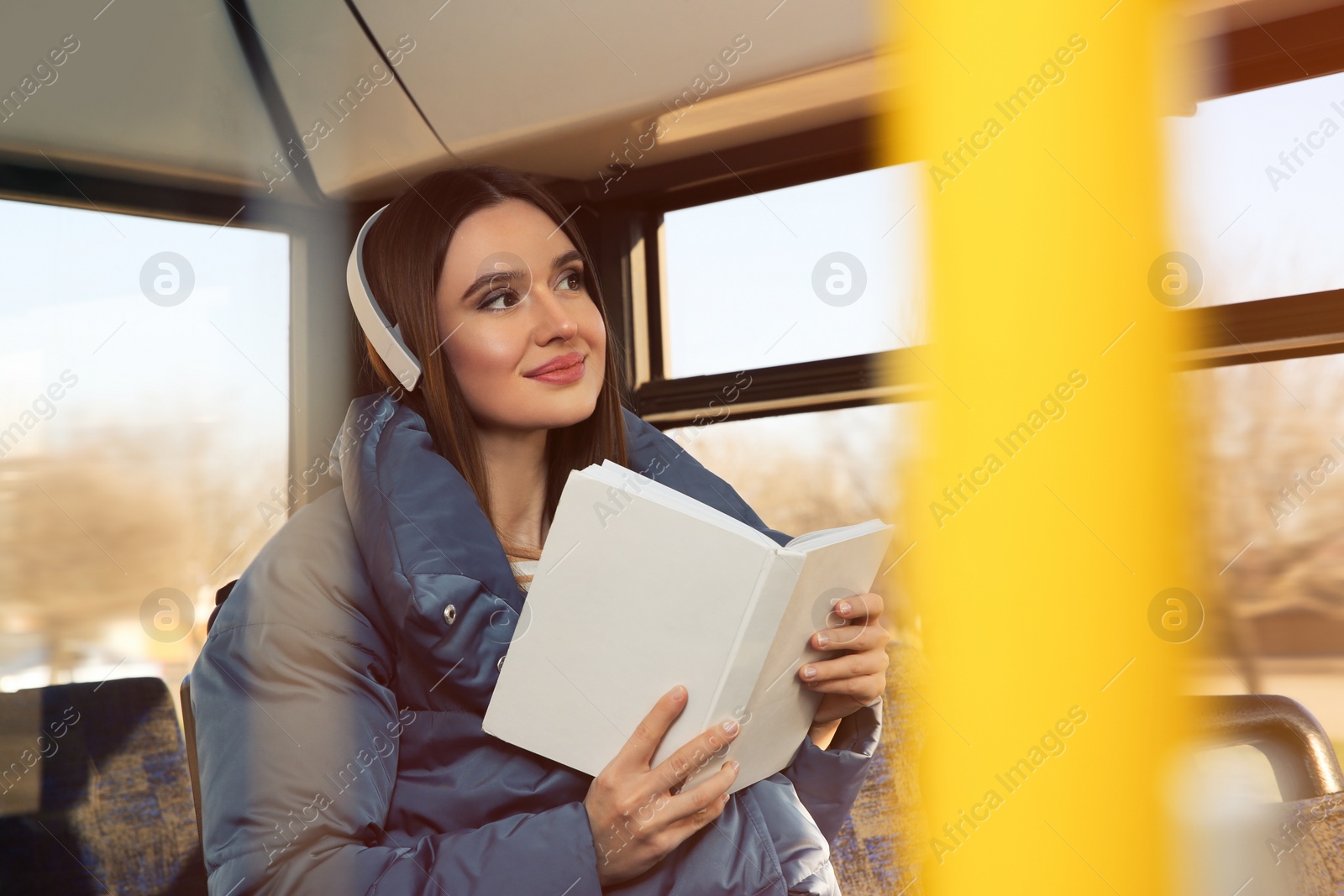 Photo of Woman listening to audiobook in trolley bus