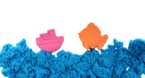 Ship, fish and sea made of kinetic sand on white background, top view