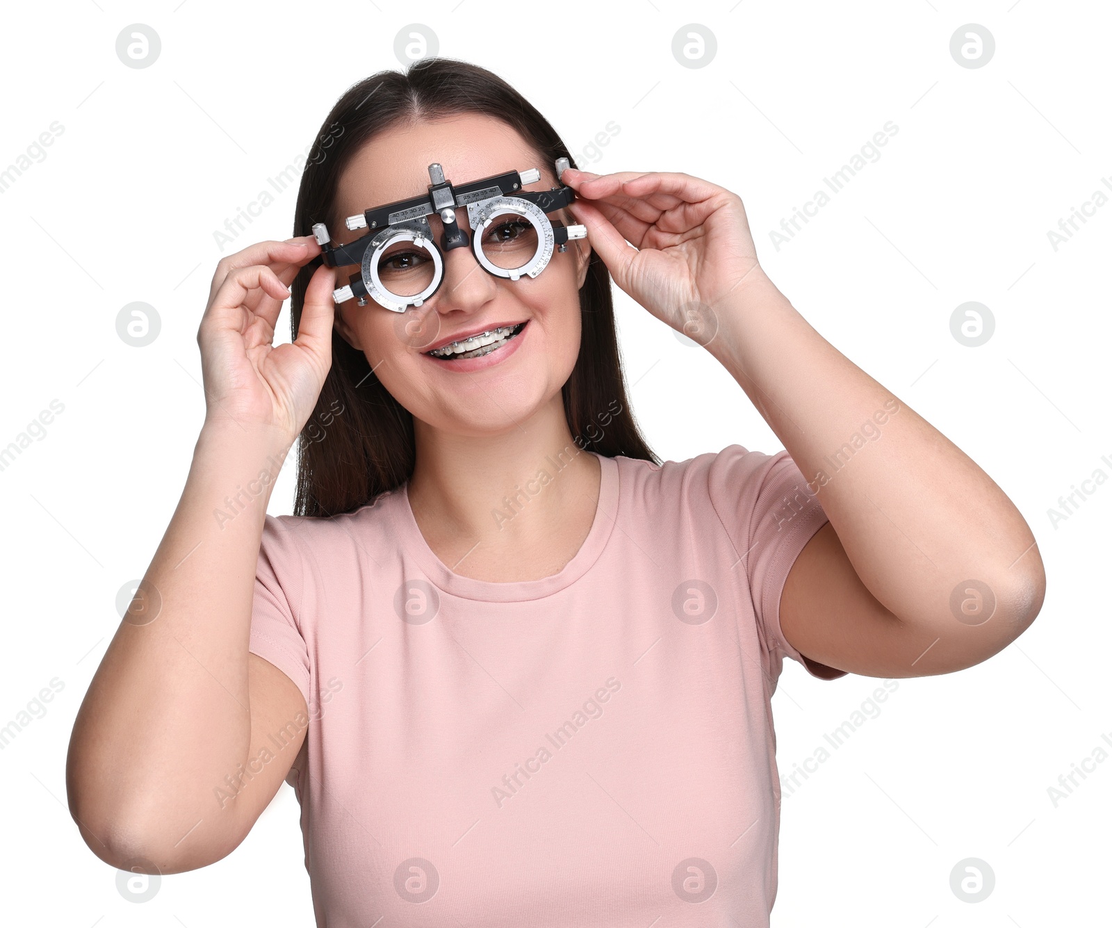 Photo of Vision testing. Young woman with trial frame on white background