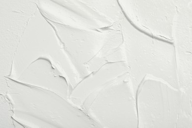 Photo of Texture of white oil paint as background, closeup