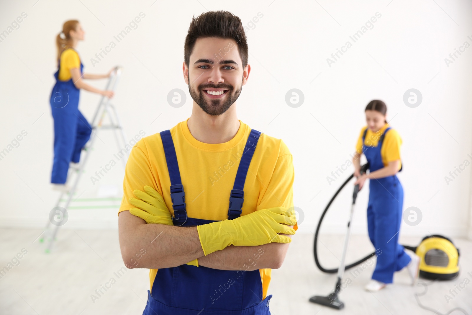 Photo of Professional janitor in uniform indoors. Cleaning service