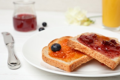 Photo of Toasts with jam on plate, closeup