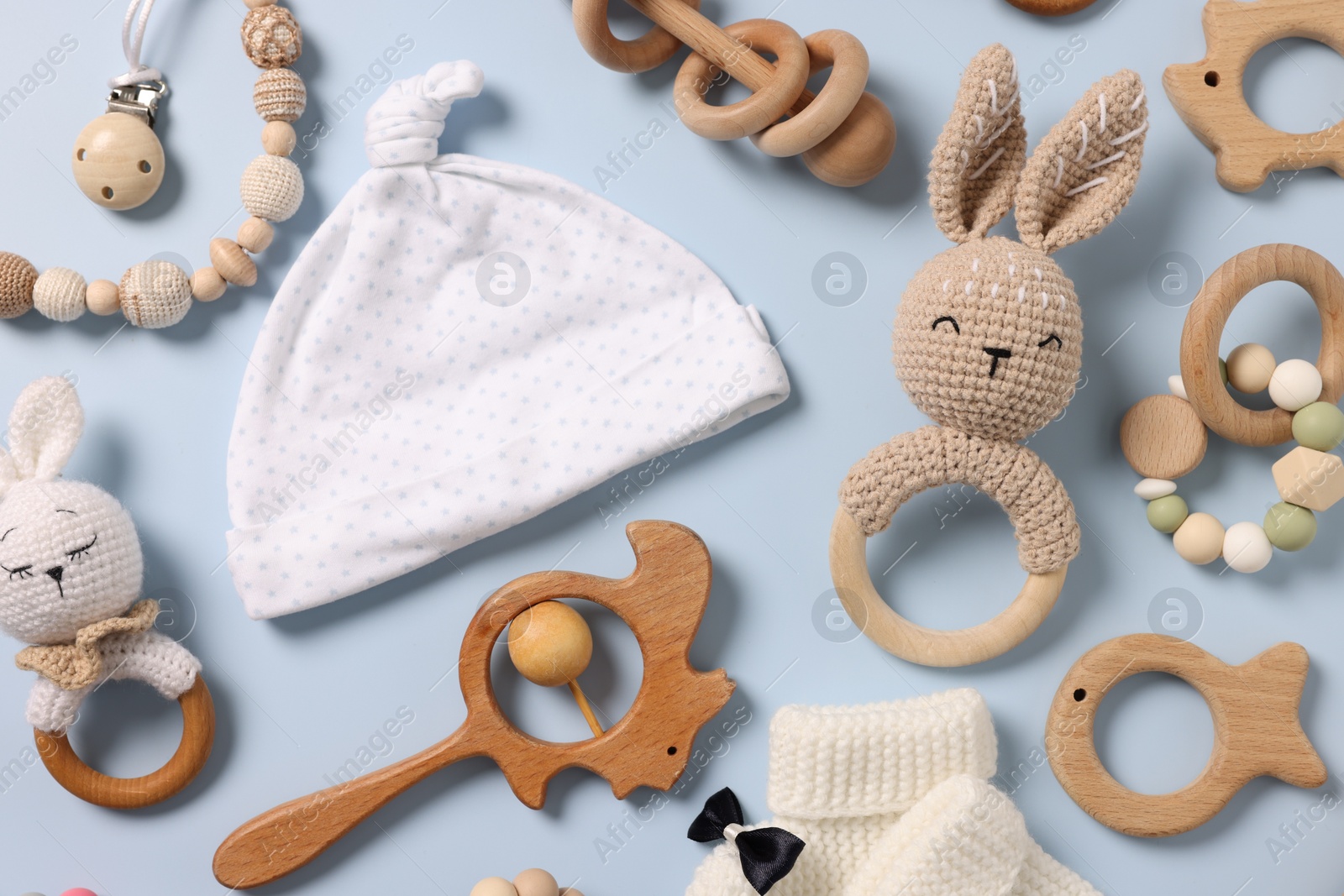 Photo of Different baby accessories on light blue background, flat lay