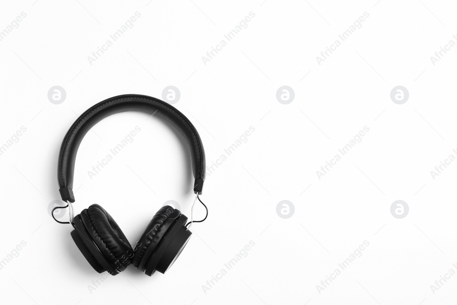 Photo of Stylish modern headphones on white background, top view