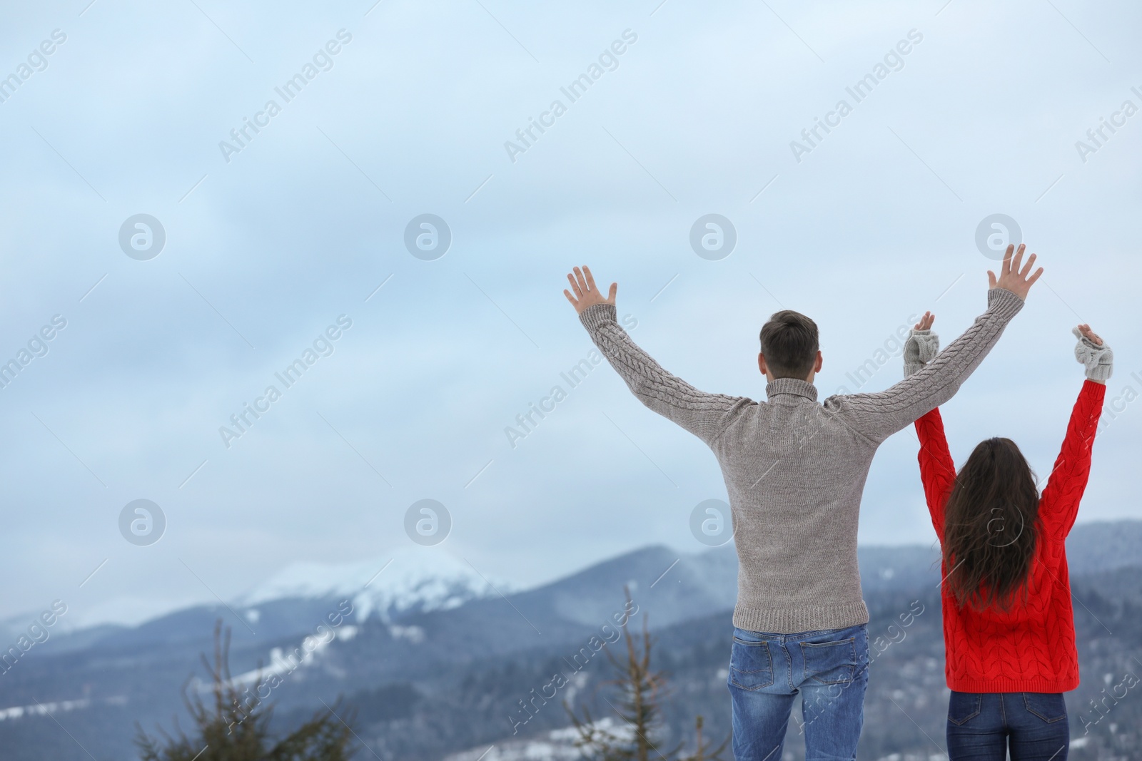 Photo of Happy couple enjoying mountain landscape in winter