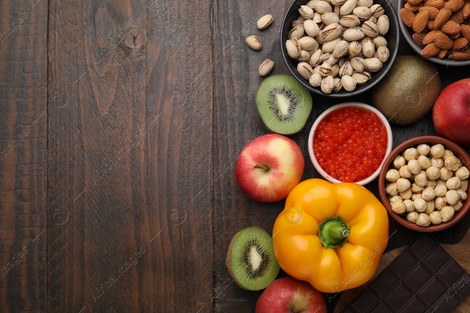 Photo of Many different products on wooden table, flat lay and space for text. Natural sources of serotonin