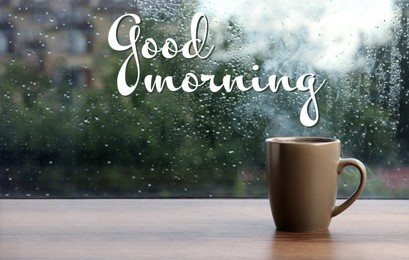Image of Cup of hot drink near window on rainy day. Good morning