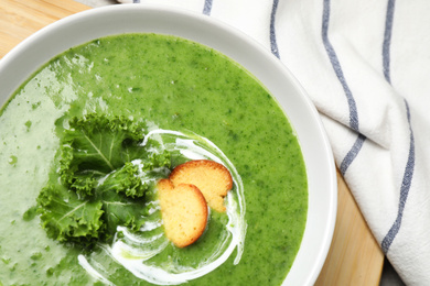 Photo of Tasty kale soup on table, closeup view