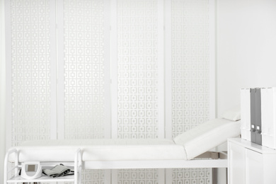 Photo of Empty examination couch in modern medical office