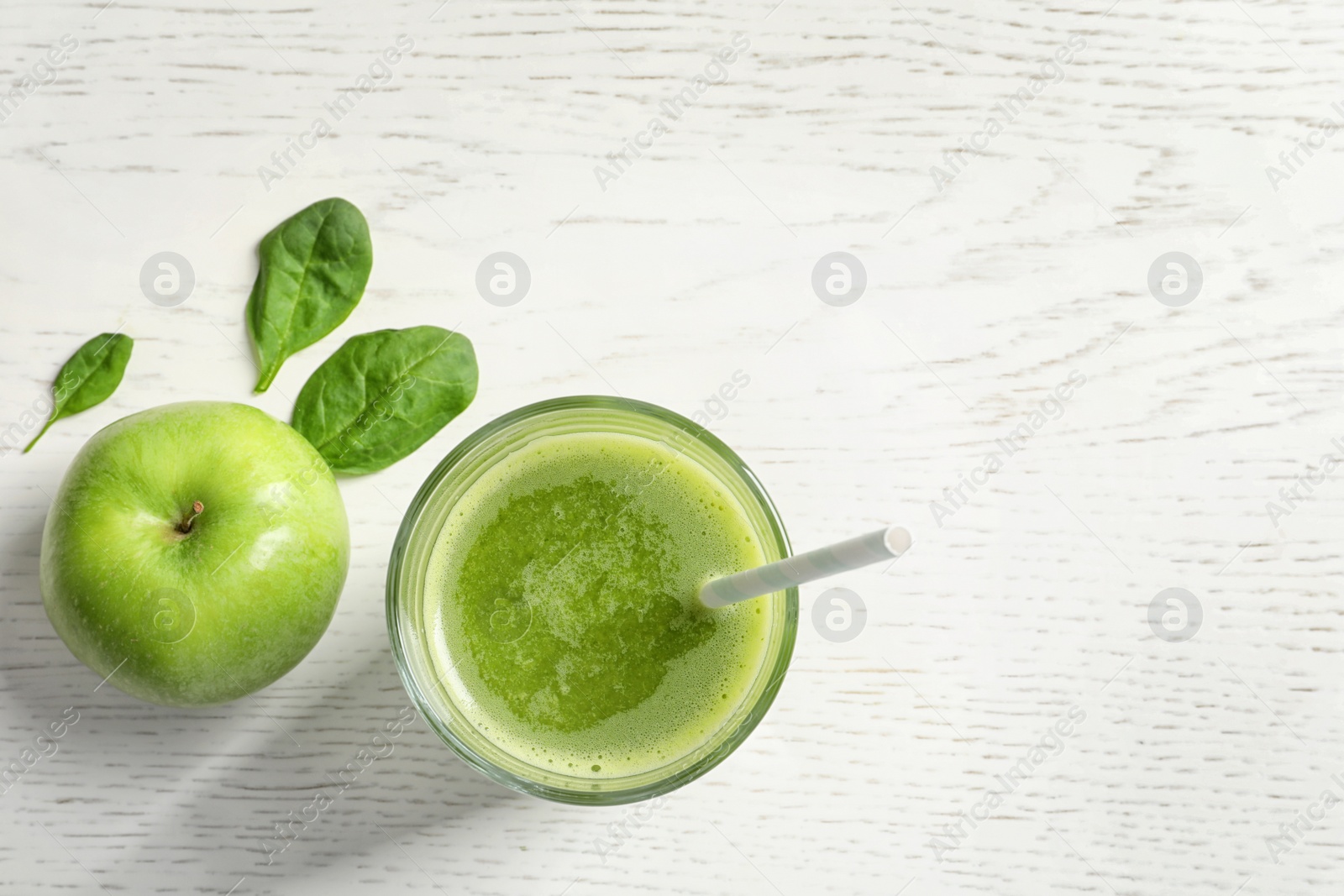 Photo of Glass with delicious detox juice and ingredients on light background, top view