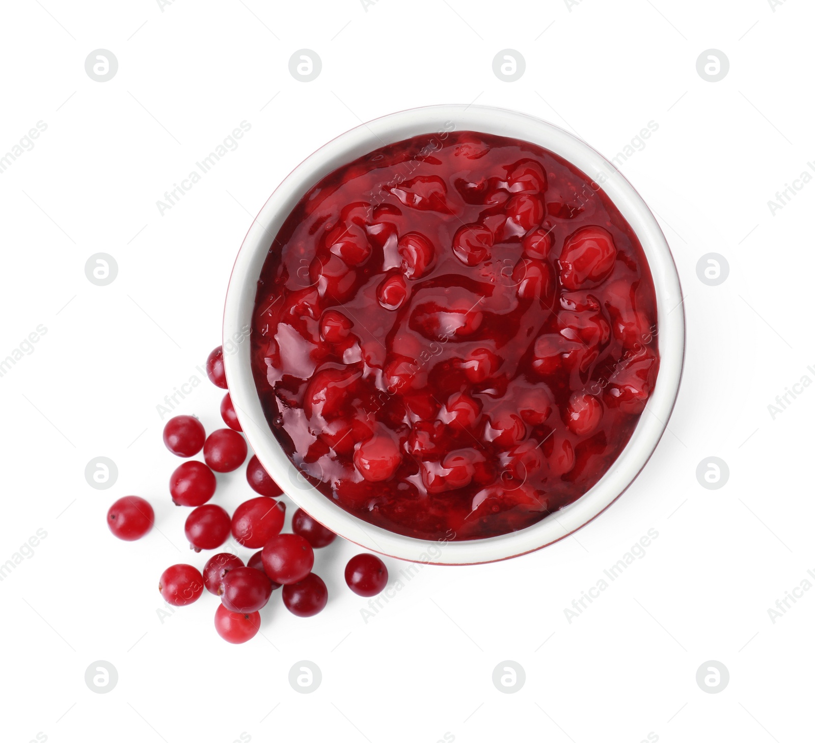 Photo of Cranberry sauce in bowl and fresh berries isolated on white, top view