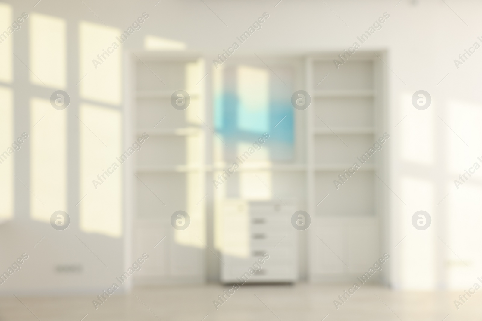 Photo of Blurred view of room with shelving unit and shadows on wall