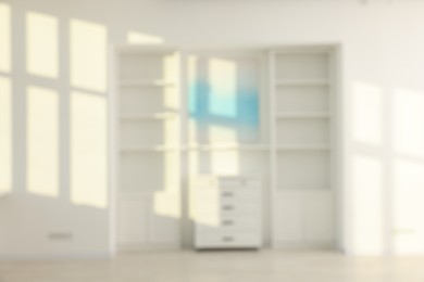 Blurred view of room with shelving unit and shadows on wall