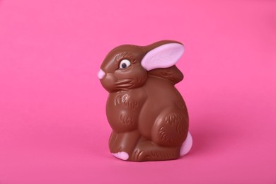 Photo of Chocolate bunny on pink background. Easter celebration