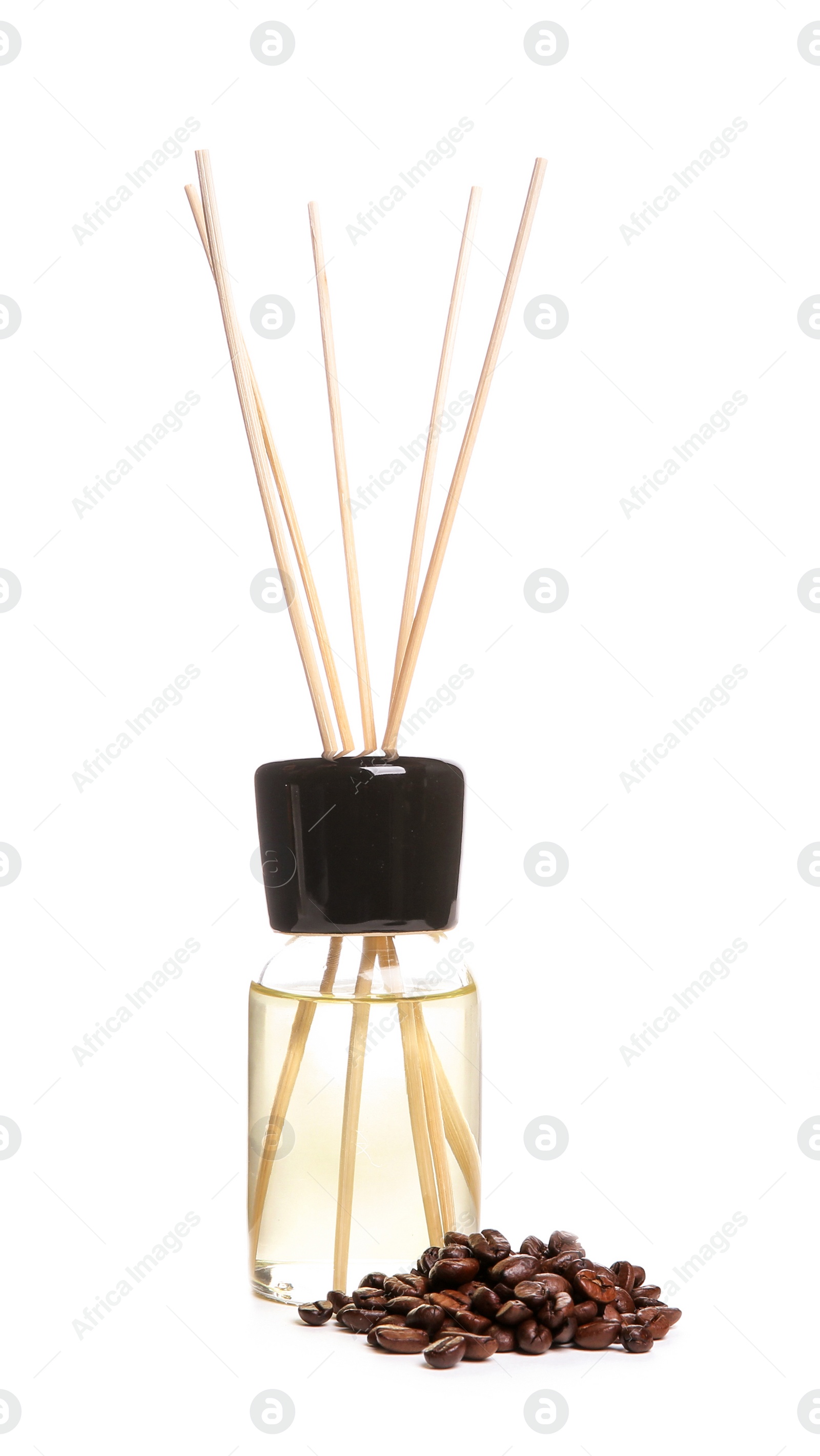 Photo of Aromatic reed air freshener and coffee beans on white background