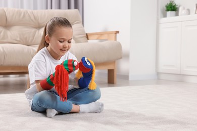 Photo of Happy daughter with funny sock puppets playing at home, space for text