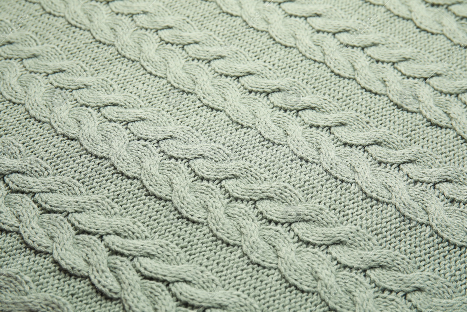 Photo of Soft knitted plaid as background, closeup view