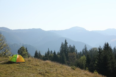 Photo of Picturesque view of camping tent in mountains. Space for text