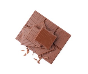 Pieces of delicious milk chocolate bar on white background, top view