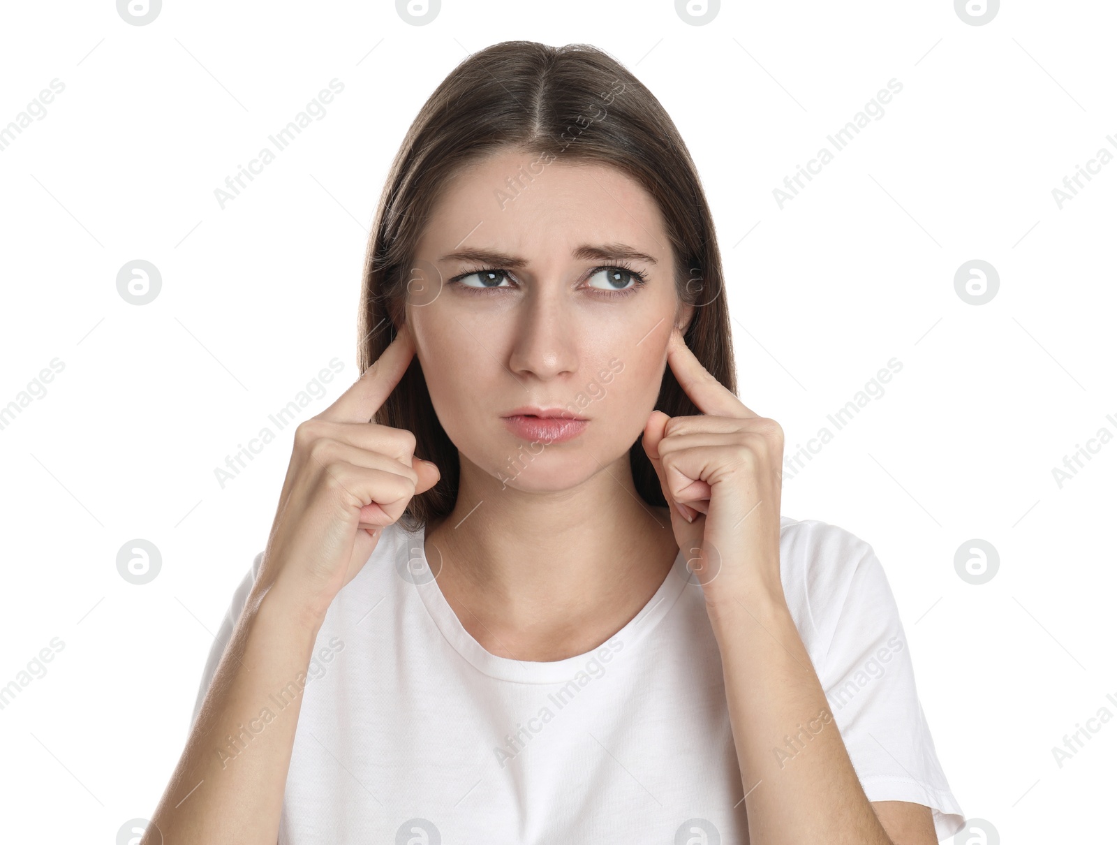 Photo of Emotional young woman covering her ears with fingers on white background