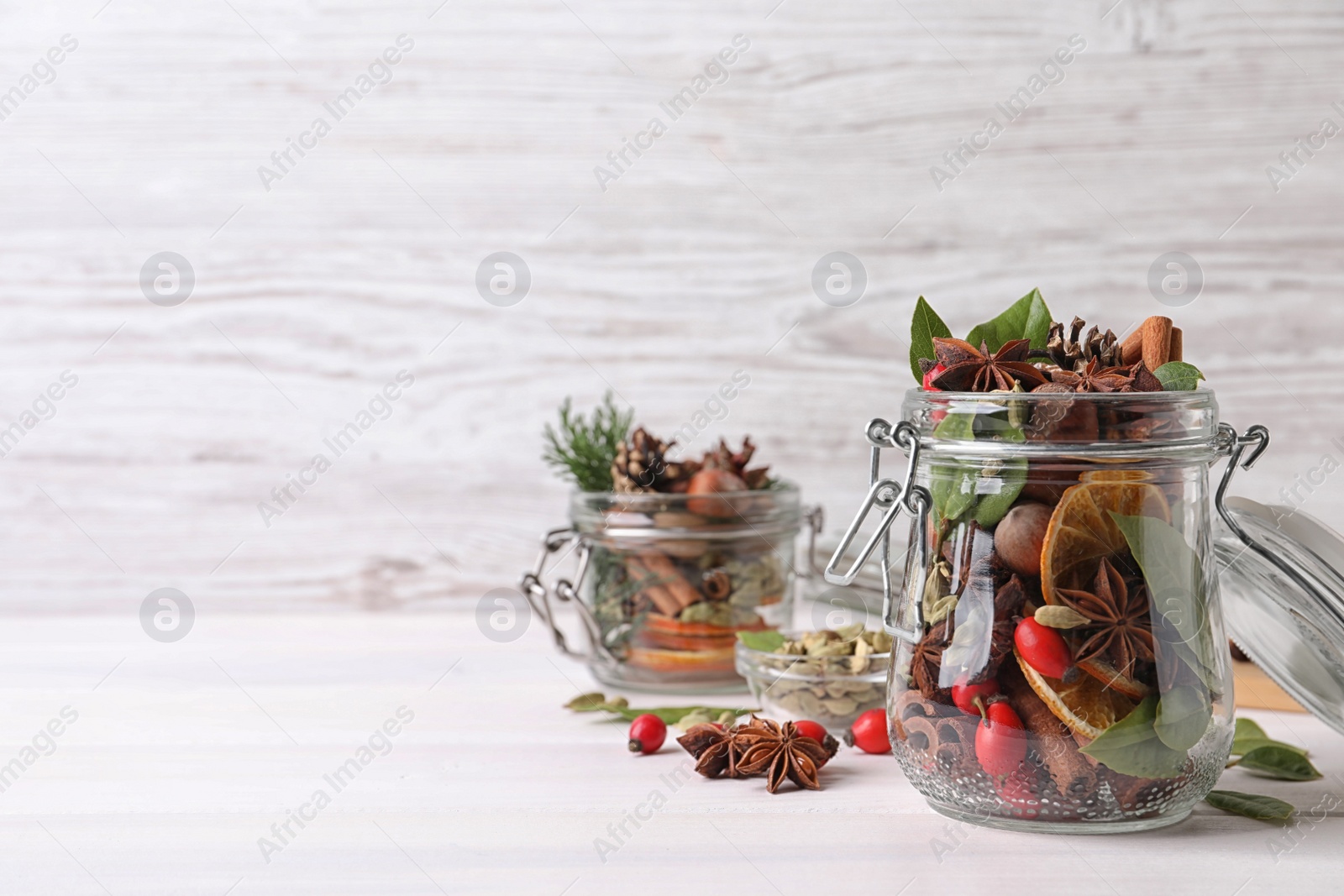 Photo of Aroma potpourri with different spices on white table, space for text