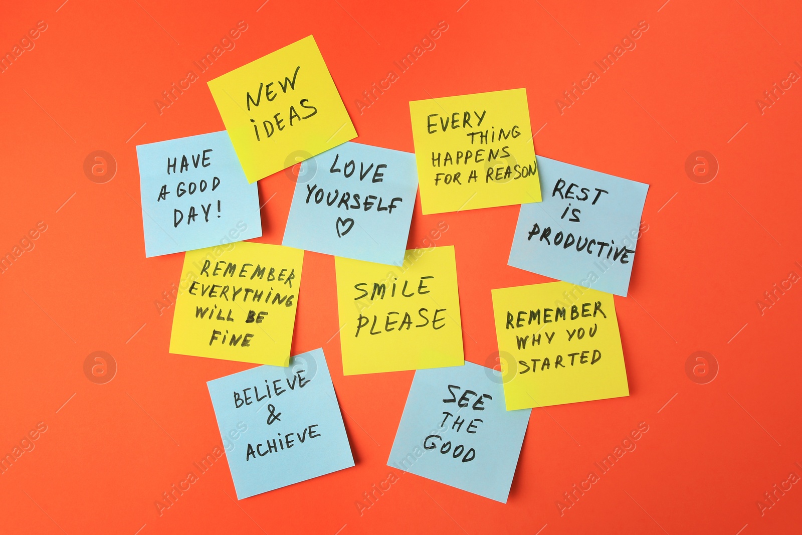 Photo of Paper notes with life-affirming phrases on orange background