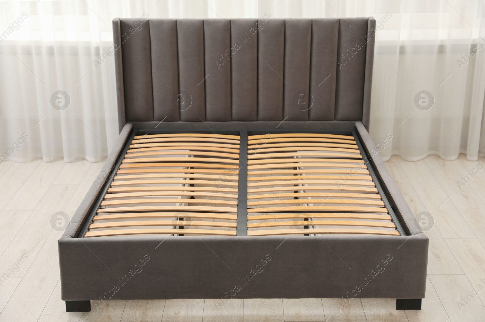 Photo of Modern bed with storage space for bedding under slatted base in room