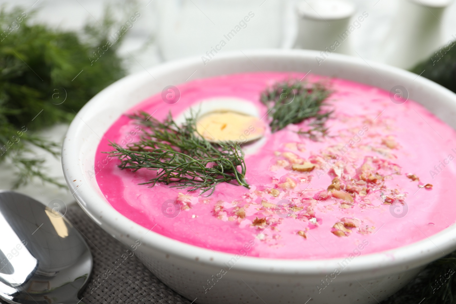 Photo of Delicious cold summer beet soup in bowl, closeup