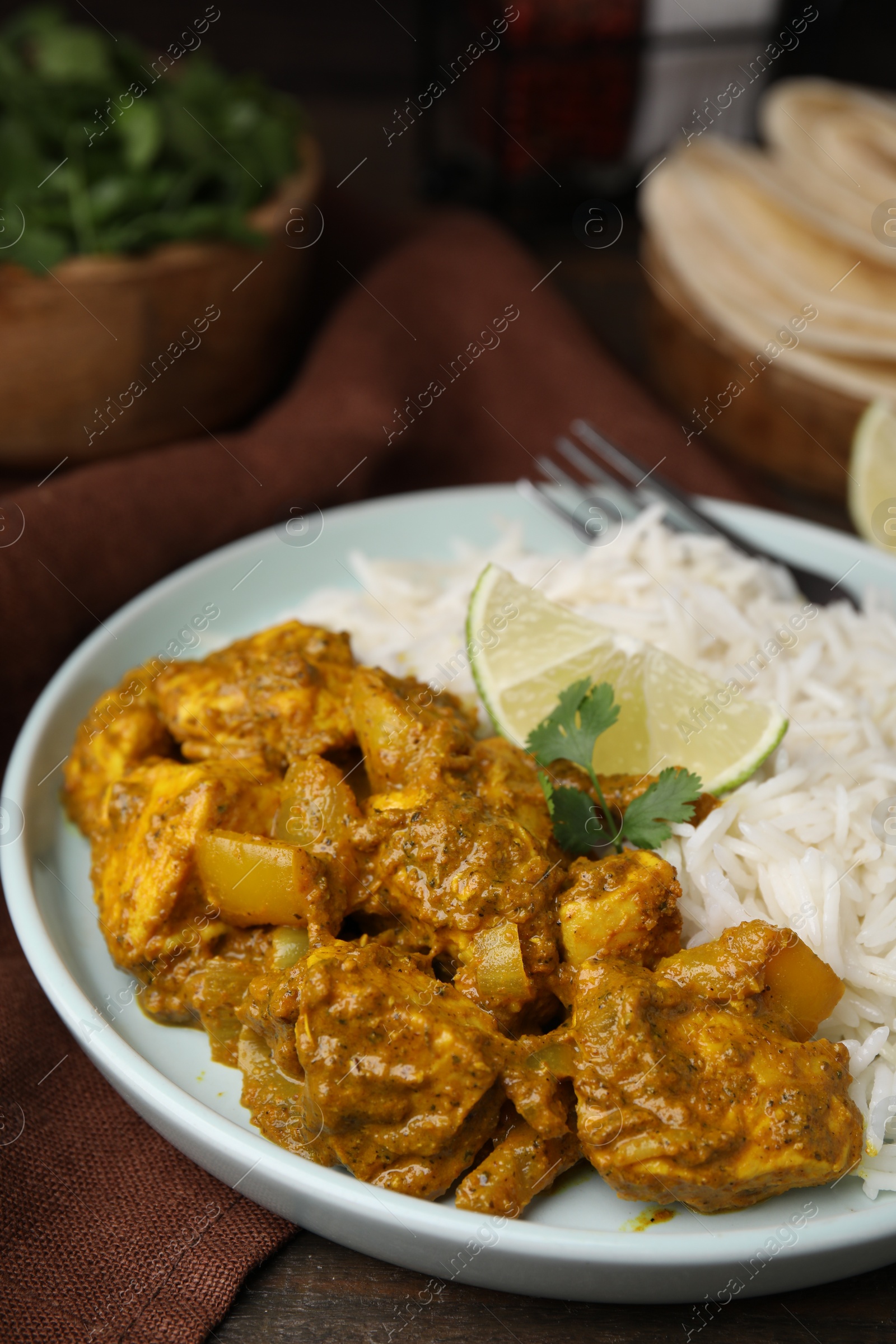 Photo of Delicious chicken curry with rice on table, closeup