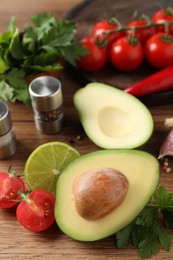 Photo of Fresh ingredients for guacamole on wooden table