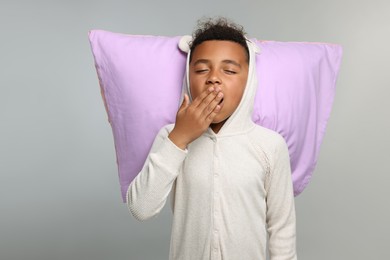 Photo of Boy with pillow on grey background. Insomnia problem