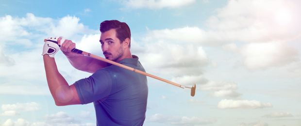 Image of Young man playing golf against blue sky. Banner design