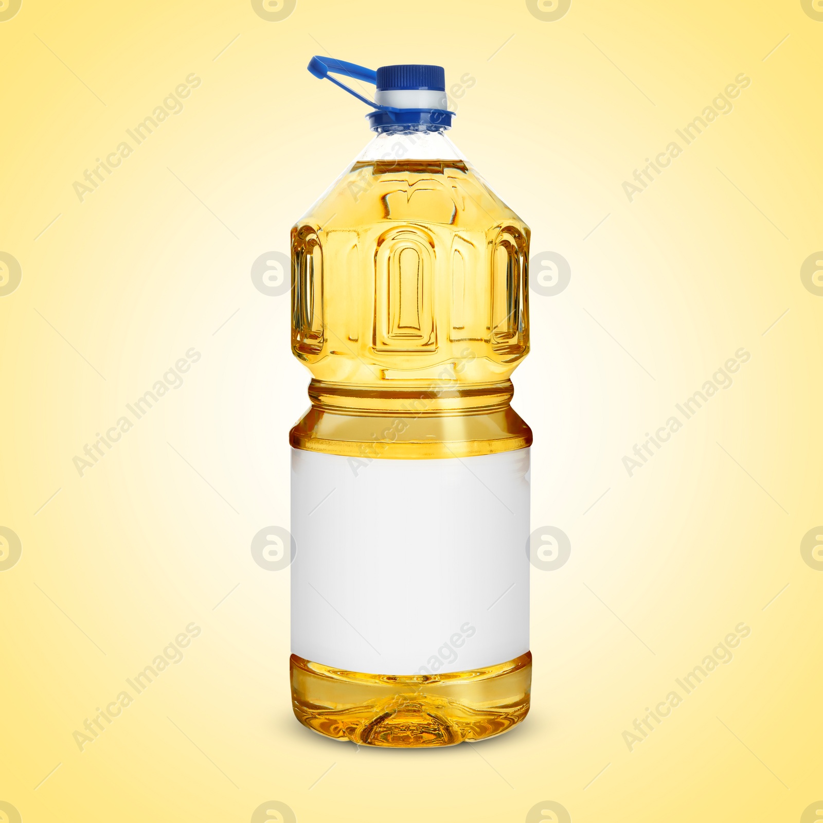 Image of Cooking oil in plastic bottle with empty label on light yellow background. Mockup for design