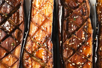 Tasty fried eggplant slices with sesame, top view