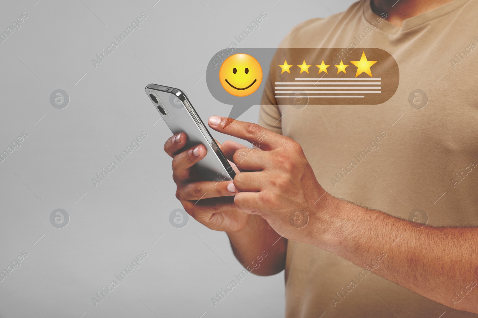 Image of Man leaving service feedback with smartphone on light background, closeup. Stars and emoticon over device