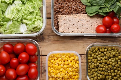 Photo of Plastic and glass containers with different fresh products on wooden table, flat lay