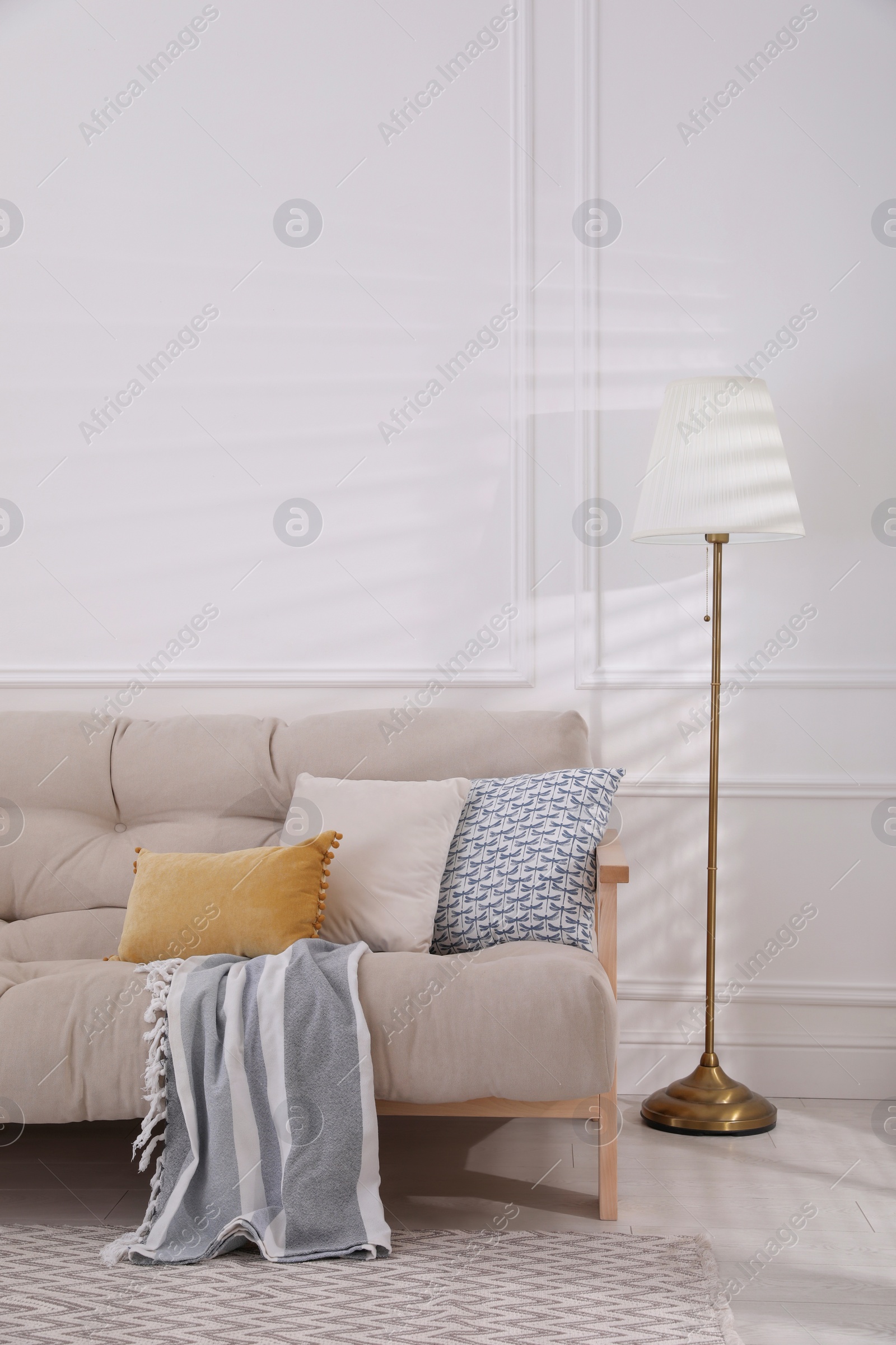 Photo of Interior of living room with comfortable sofa and floor lamp