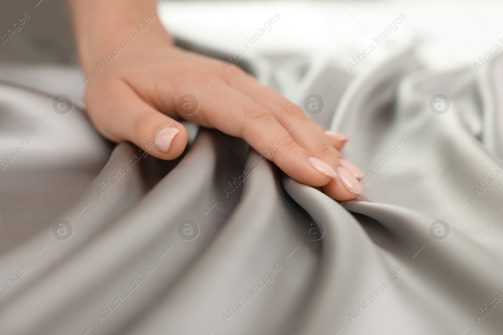 Photo of Woman touching smooth silky fabric, closeup view