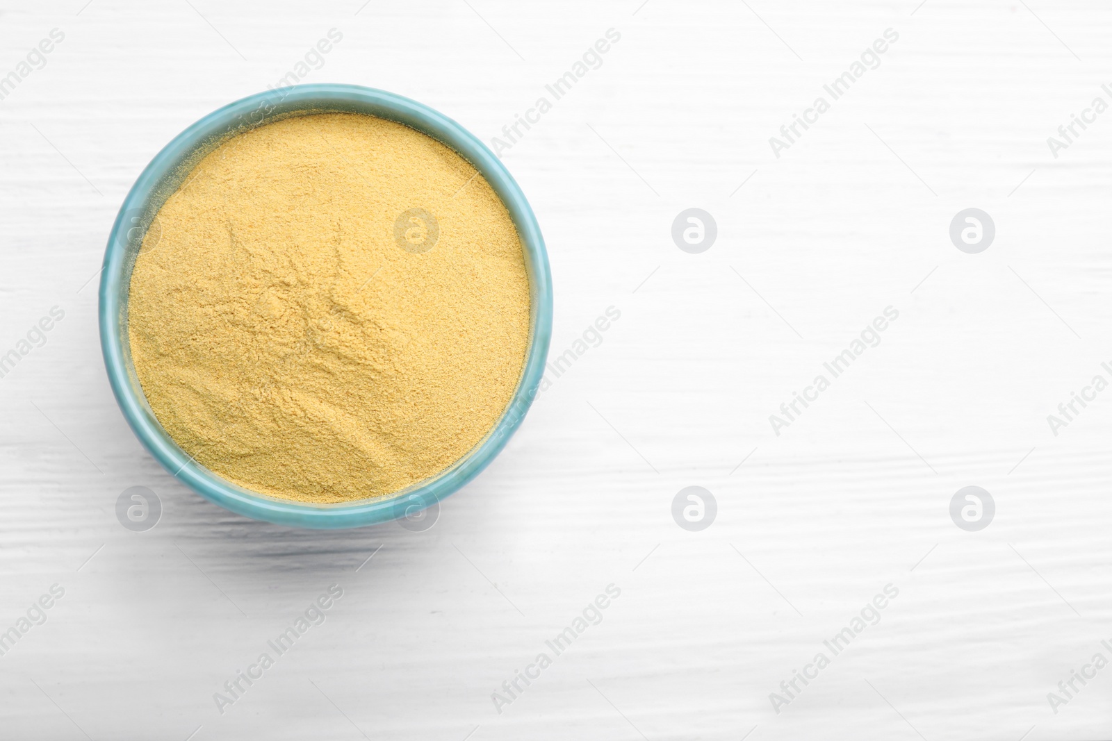 Photo of Beer yeast powder on white wooden table, top view. Space for text