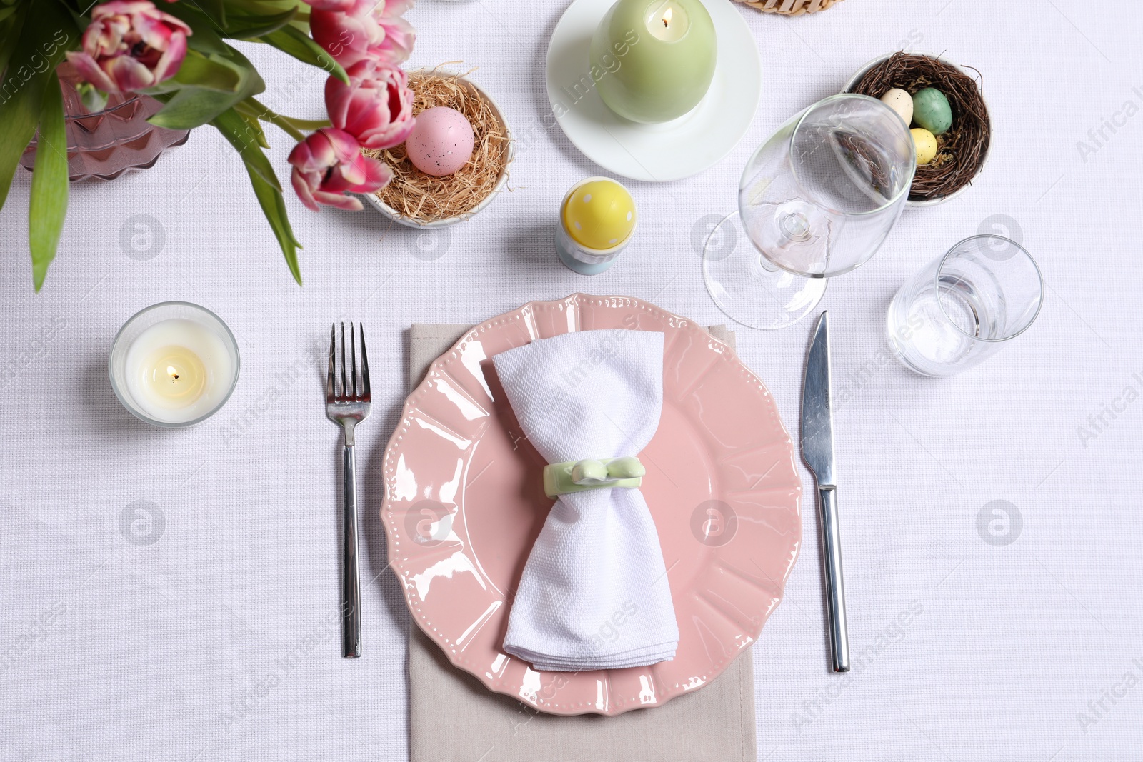 Photo of Festive table setting with beautiful flowers, flat lay. Easter celebration