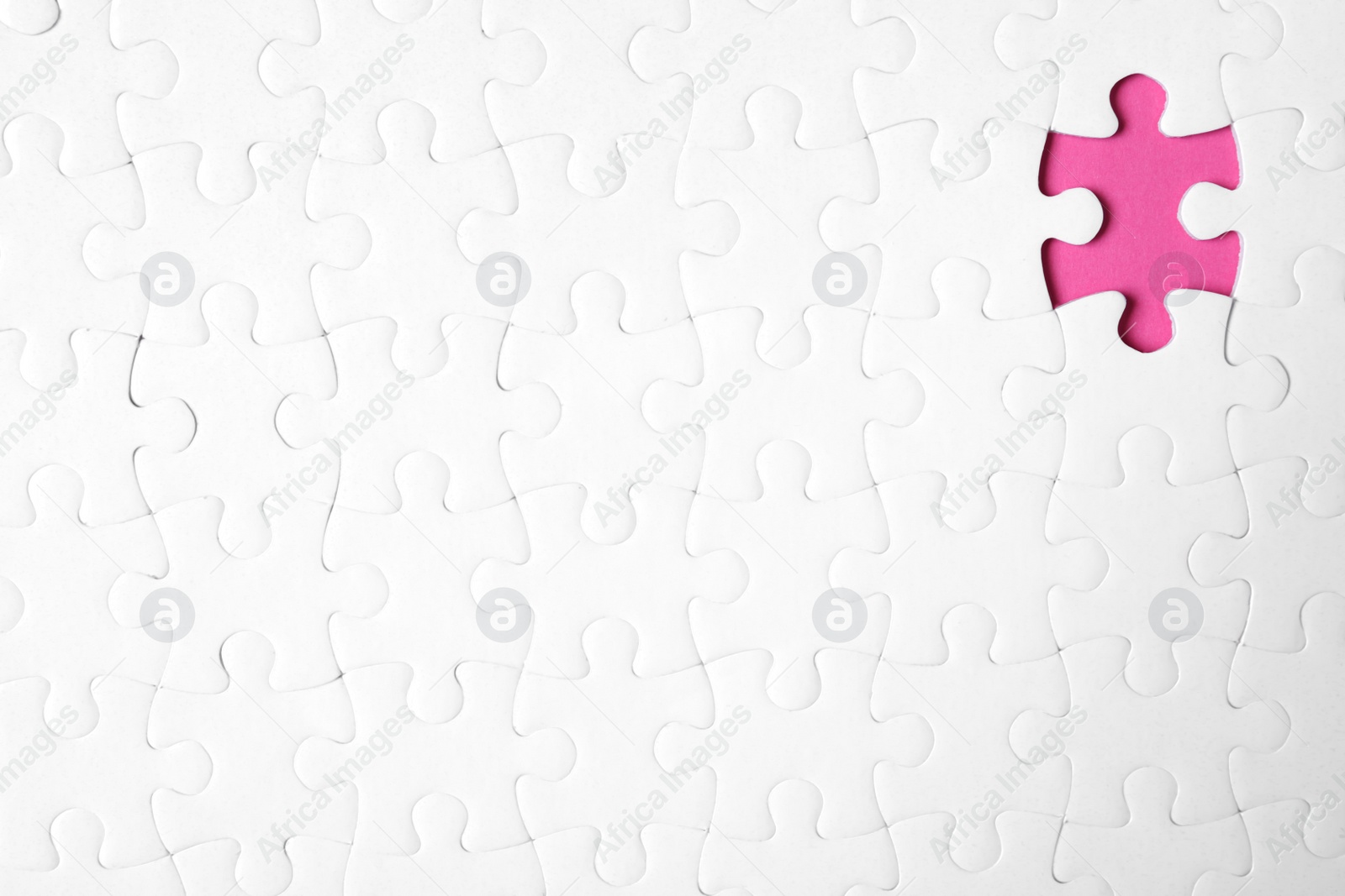 Photo of Blank white puzzle with missing piece on pink background, top view. Space for text