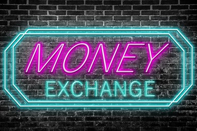 Money Exchange neon sign on brick wall. Bright frame with text