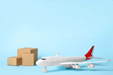 Photo of Toy plane on blue  background, space for text. Logistics and wholesale concept