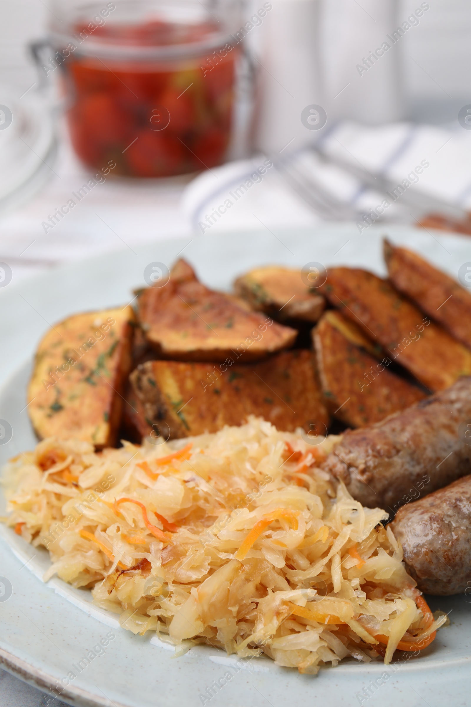 Photo of Plate with sauerkraut, sausages and potatoes on table, closeup