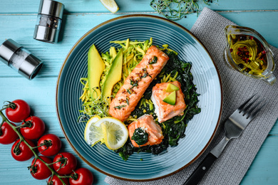 Tasty salmon with spinach served on blue wooden table, flat lay. Food photography  