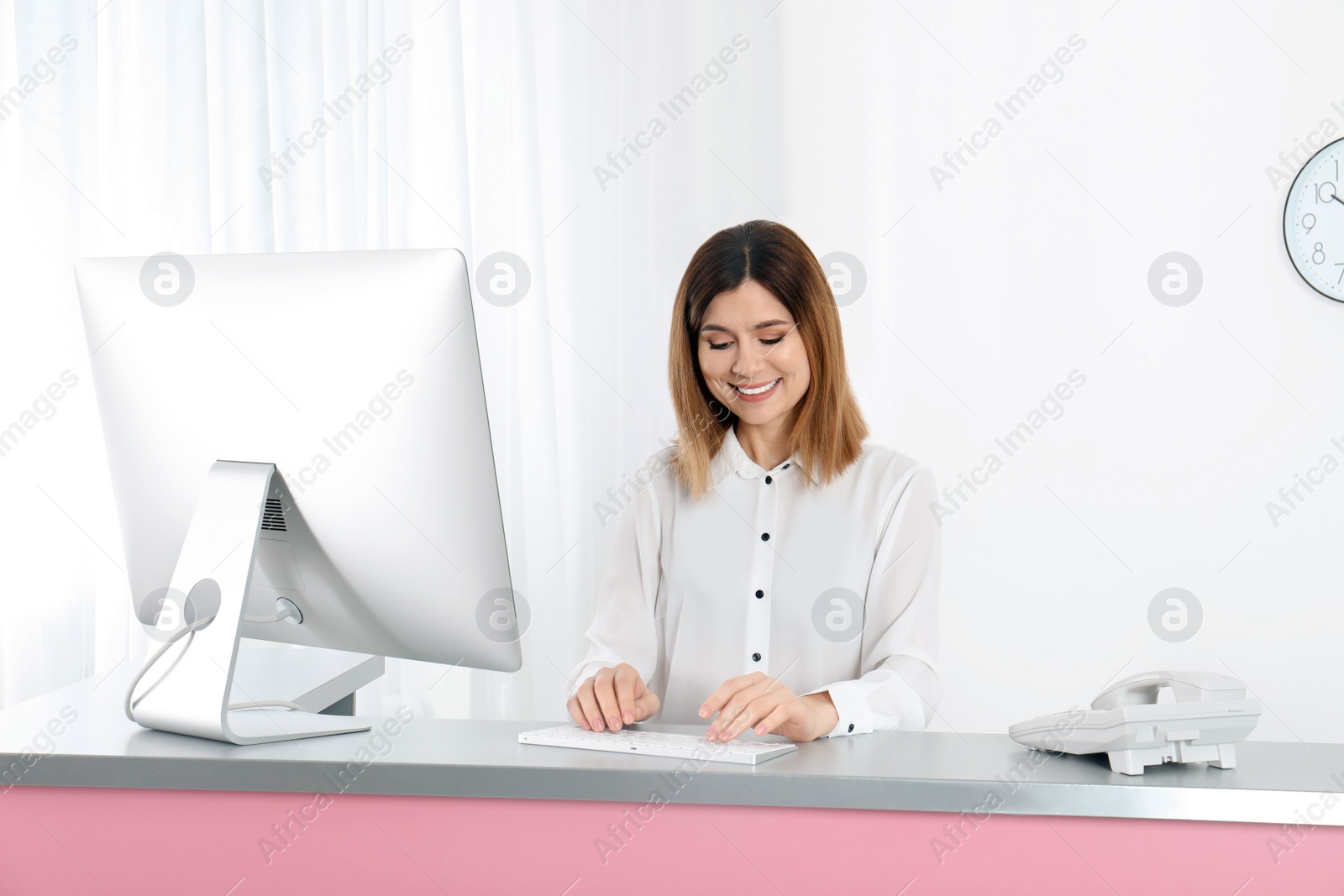 Photo of Beautiful woman working at reception desk in beauty salon