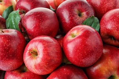 Photo of Many ripe juicy red apples as background