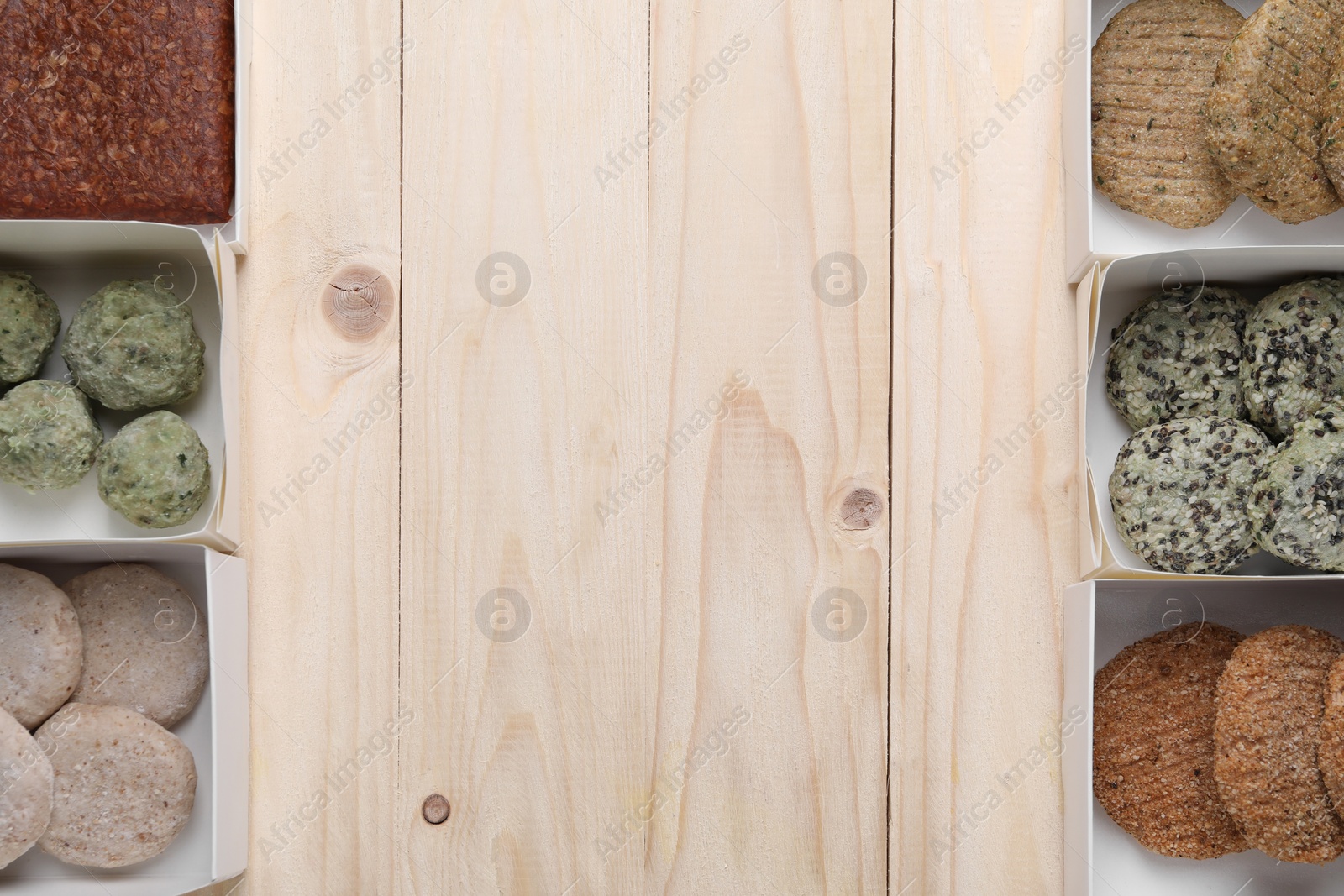 Photo of Many different raw vegan meat products on wooden table, flat lay. Space for text