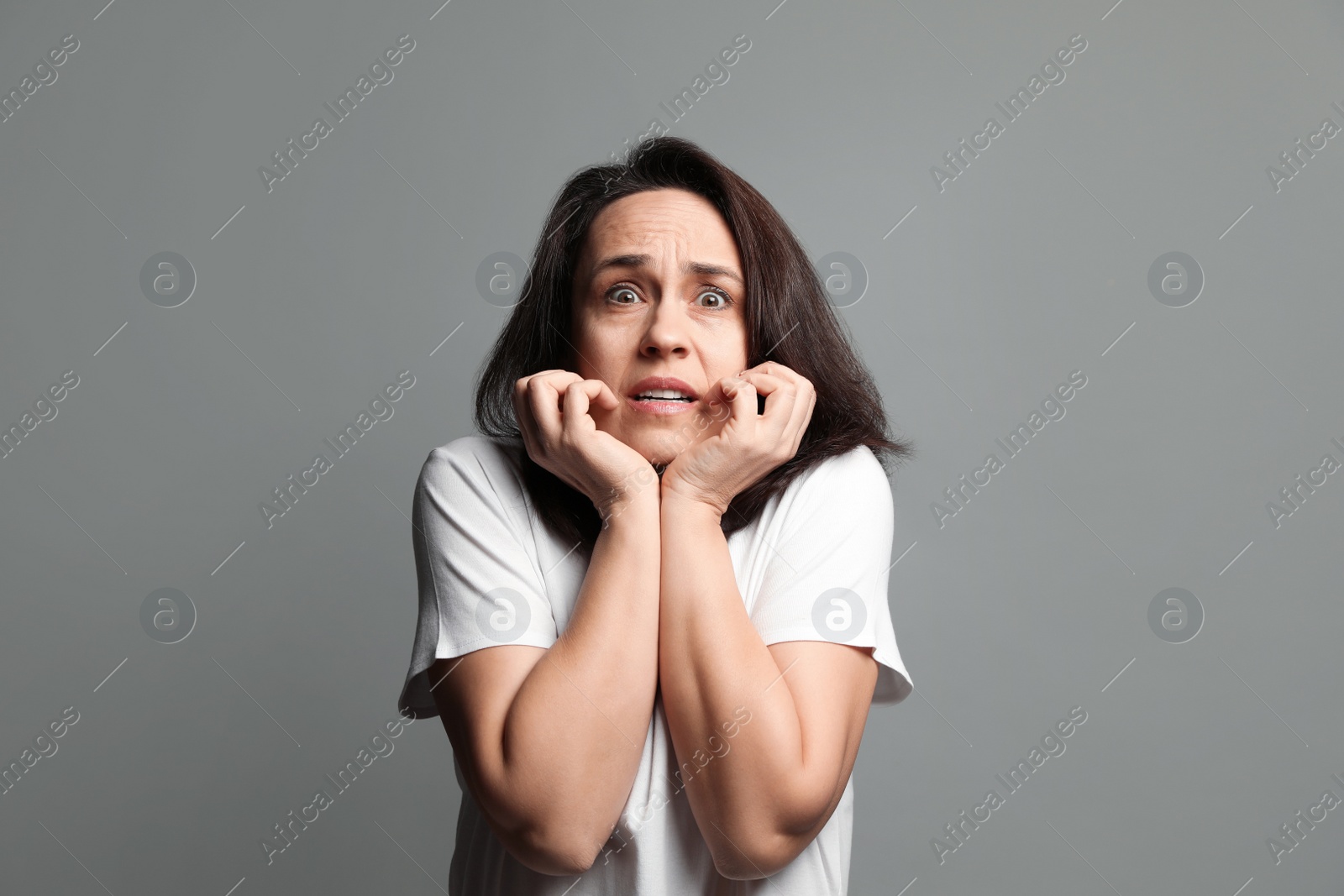 Photo of Mature woman feeling fear on grey background